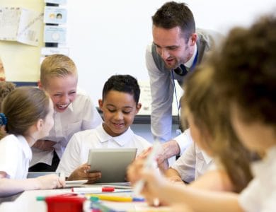 Teacher supporting his students