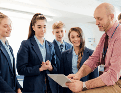 Teacher showing students something on an ipad