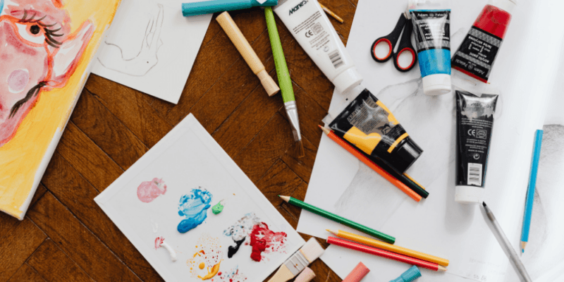 Paint and art class equipment on a table