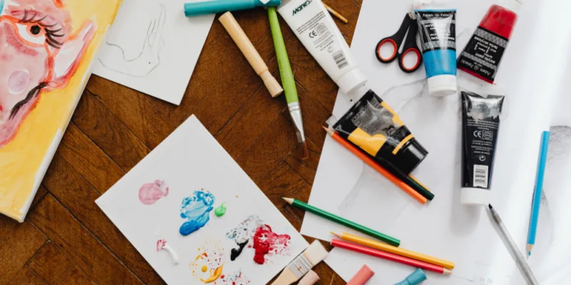 Paint and art class equipment on a table