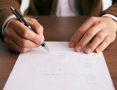 Close up of someone writing on some paper